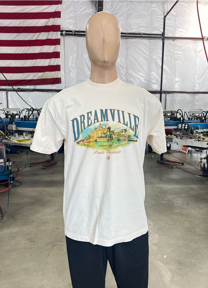 This is a photo of a white t-shirt with a water-based screen print design on the front and it's on a mannequin.